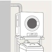 壁に穴を開けて排湿筒を通し、洗濯機の上に設置した乾太くん